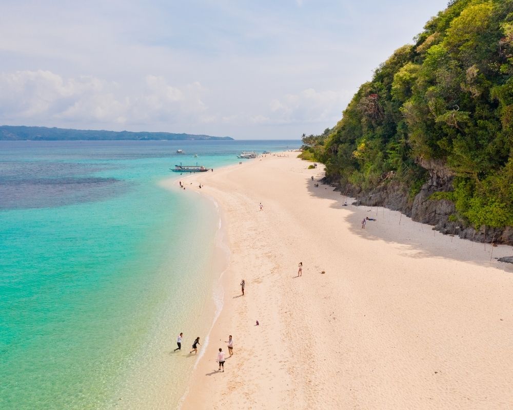 Puka Beach for island hopping and sunbathing