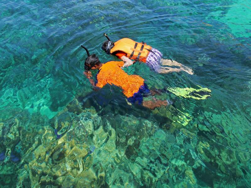 A couple new to snorkeling enjoying the fish life in Boracay